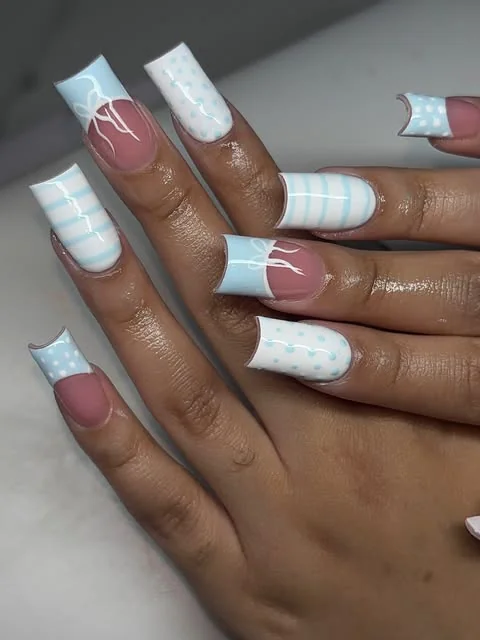 White French tips with raised bows, pearl details and striped accents.